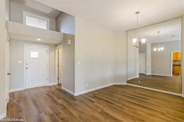 interior space with wood-type flooring and a notable chandelier