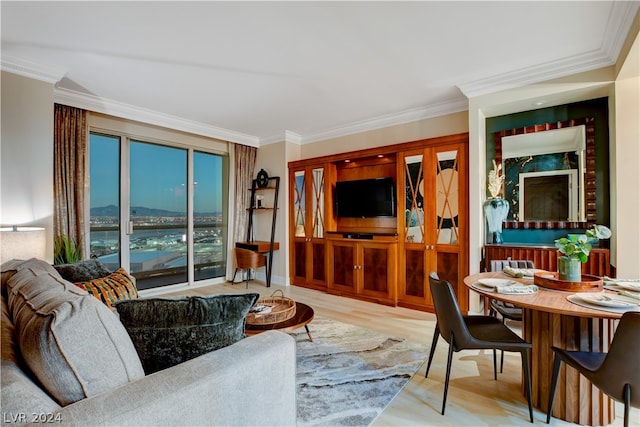 living room with light hardwood / wood-style flooring and ornamental molding