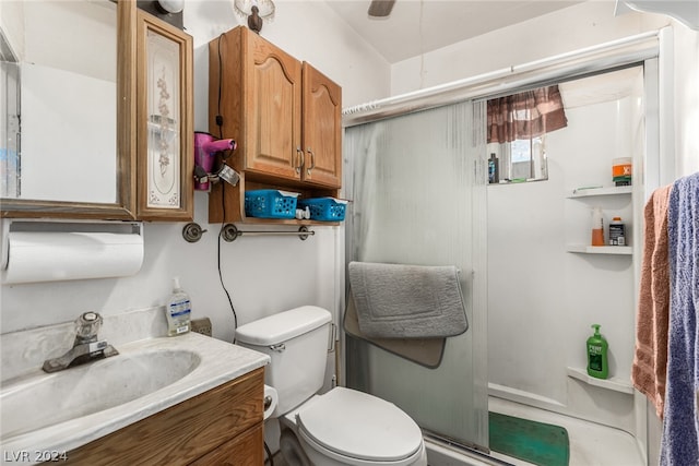 bathroom featuring vanity, toilet, and an enclosed shower