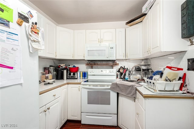 kitchen featuring white cabinetry, tasteful backsplash, and white appliances