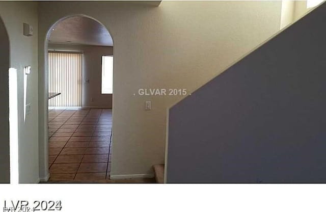 hallway with tile patterned flooring