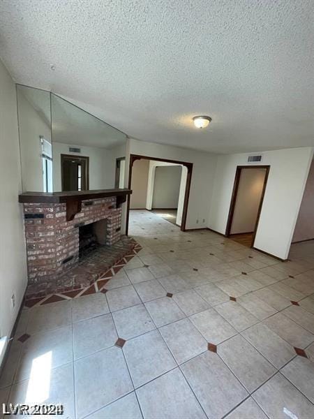 interior space featuring a fireplace and a textured ceiling