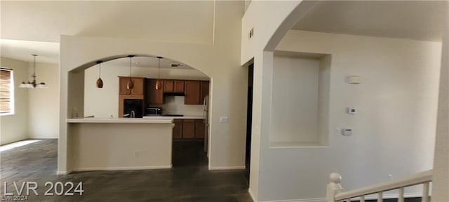 kitchen featuring decorative light fixtures and a notable chandelier