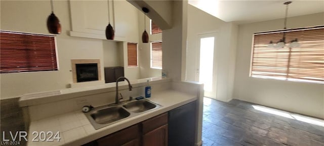 kitchen with sink, light hardwood / wood-style flooring, and decorative light fixtures