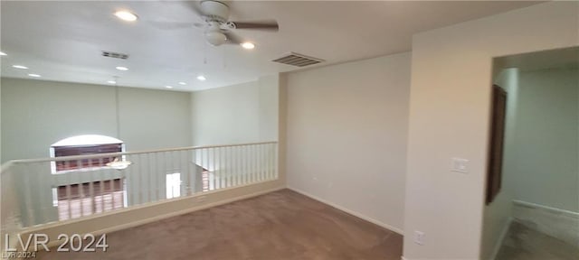 unfurnished room with ceiling fan and carpet flooring