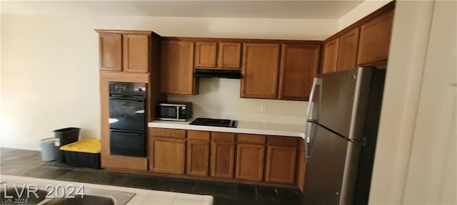 kitchen with stainless steel appliances and tile patterned flooring