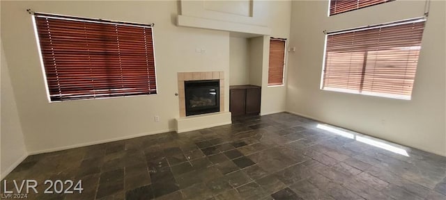 unfurnished living room with a tile fireplace