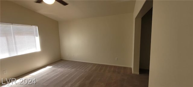 carpeted empty room featuring ceiling fan and lofted ceiling