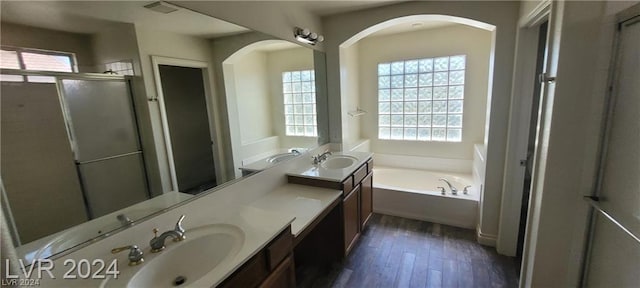 bathroom with vanity, wood-type flooring, and independent shower and bath