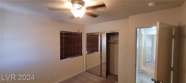 unfurnished bedroom with ceiling fan and a closet