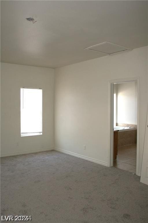 unfurnished room with baseboards and carpet floors