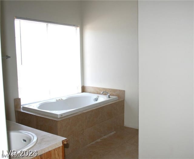 full bath featuring vanity, tile patterned floors, and a bath