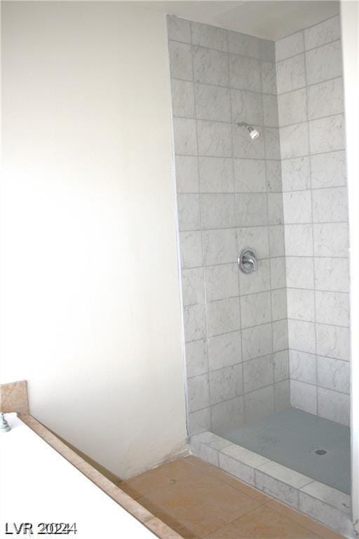 bathroom with tiled shower