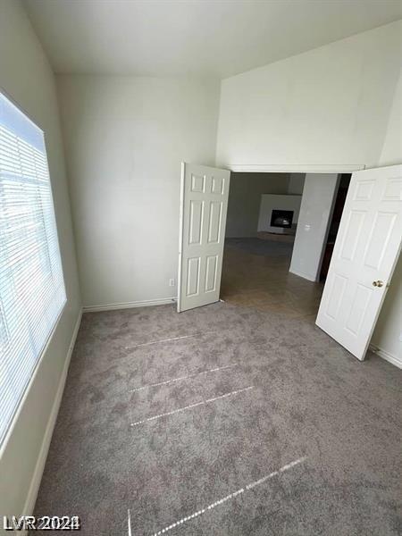 carpeted spare room with baseboards