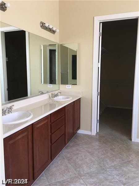 bathroom with dual vanity and tile patterned flooring