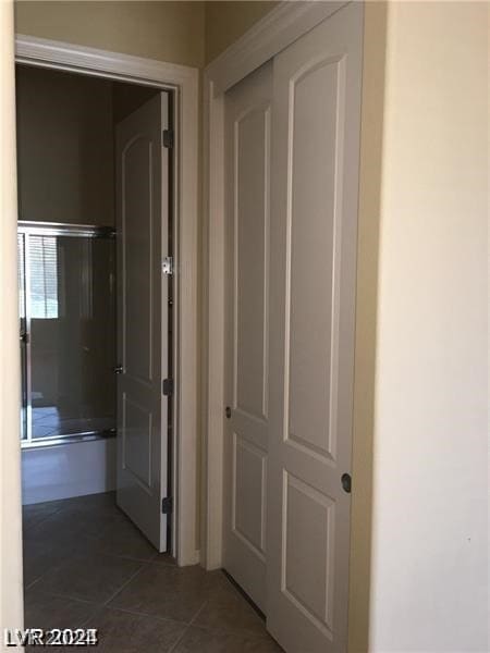 corridor featuring dark tile patterned flooring