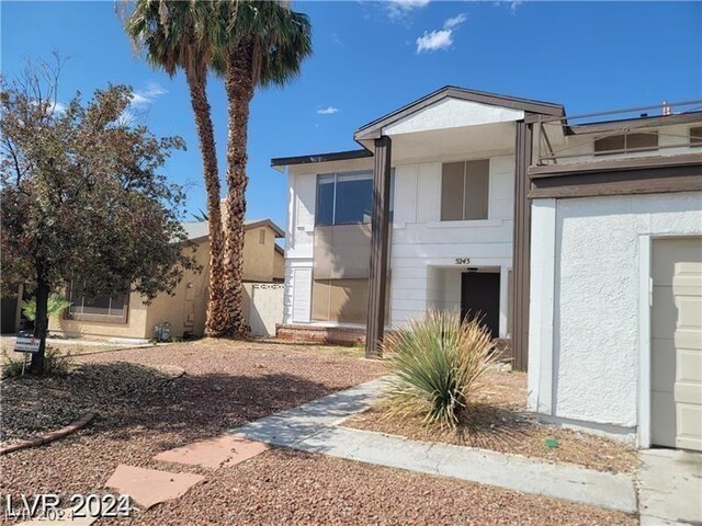 back of property with a garage