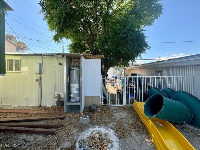 view of yard with gas water heater, fence, and a gate