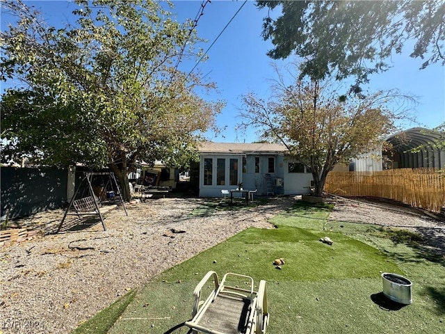 rear view of house with a fenced backyard