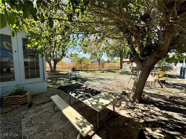 view of yard with fence and a patio