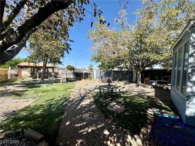 view of yard featuring a patio area, a fenced backyard, and a gazebo