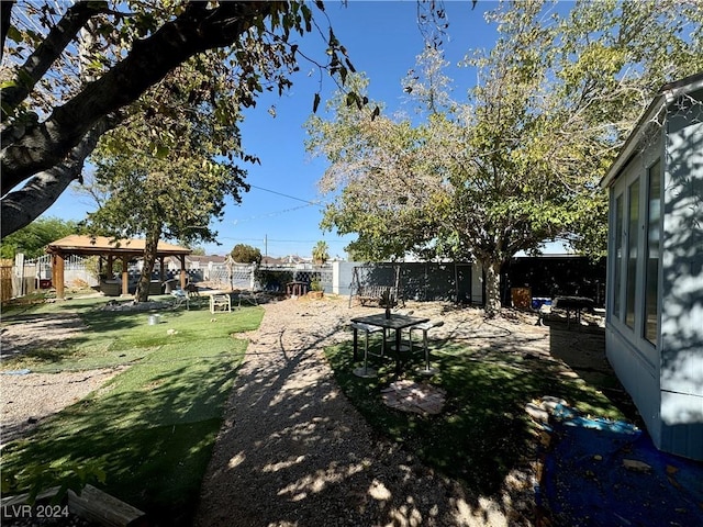 view of yard featuring a fenced backyard, a patio, and a gazebo