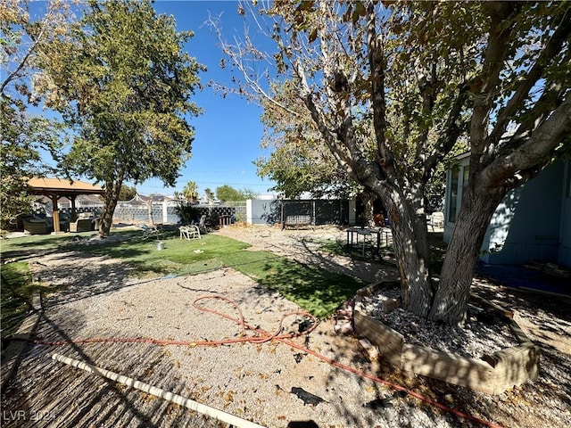 view of yard featuring fence and a gazebo