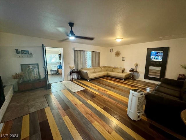 living area featuring a textured ceiling and wood finished floors