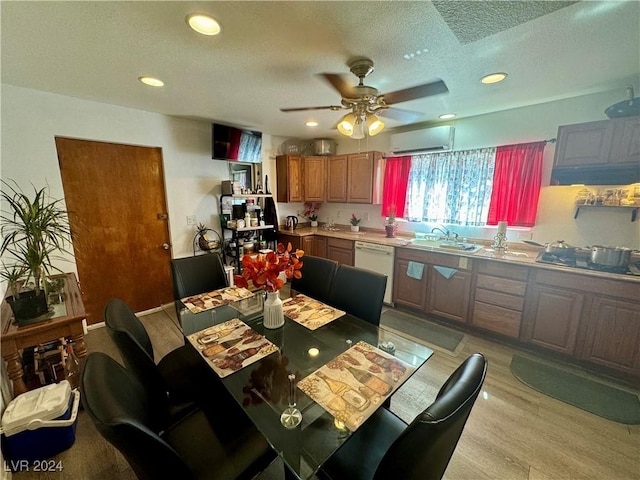 dining space with recessed lighting, light wood-style floors, a ceiling fan, a textured ceiling, and a wall mounted air conditioner