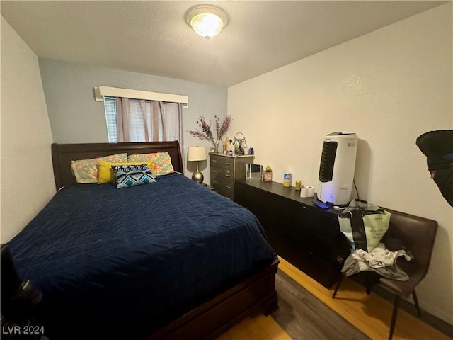 bedroom featuring wood finished floors