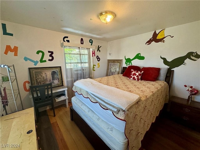 bedroom featuring wood finished floors