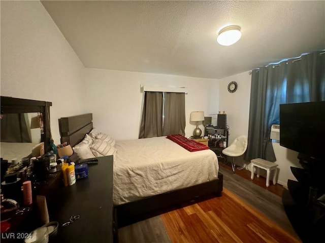 bedroom featuring a textured ceiling and wood finished floors