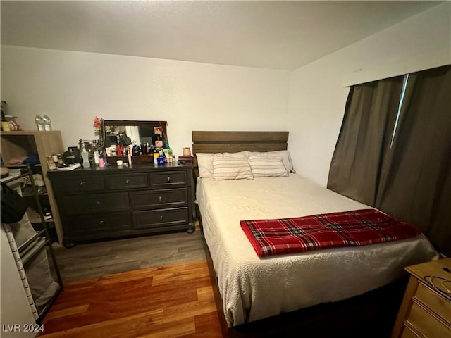 bedroom with dark wood-style floors