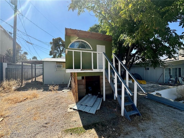 rear view of property featuring fence