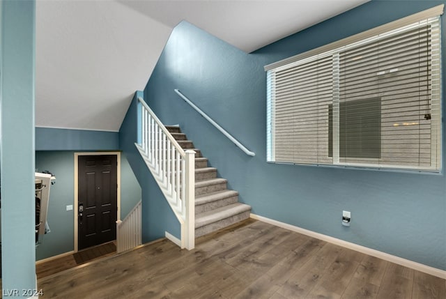 stairs featuring hardwood / wood-style flooring