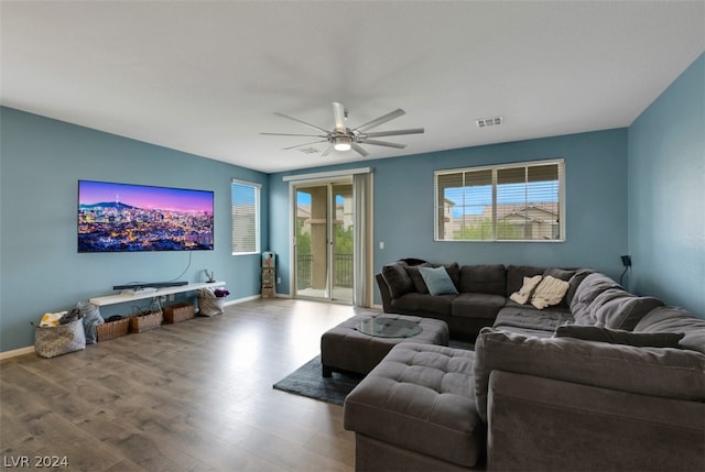 living room featuring ceiling fan and hardwood / wood-style floors