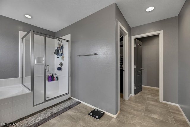 bathroom featuring tile patterned flooring and shower with separate bathtub