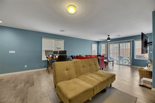 living room featuring light hardwood / wood-style floors and ceiling fan