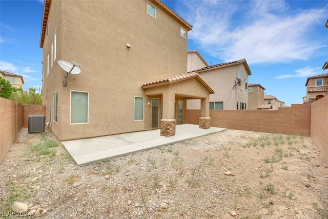 rear view of house featuring a patio and central AC