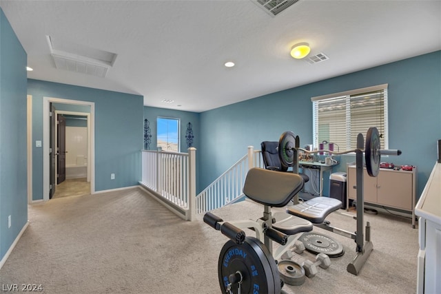 exercise room with light colored carpet