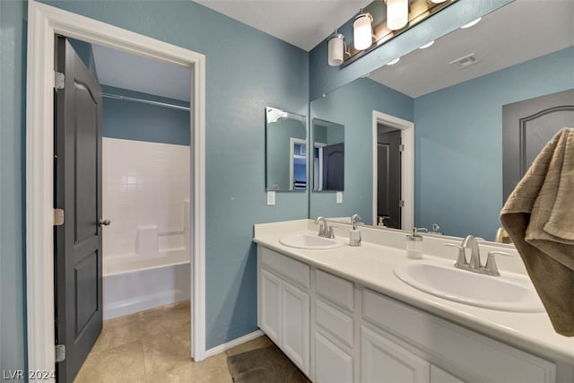 bathroom with dual vanity, tile patterned floors, and shower / bath combination