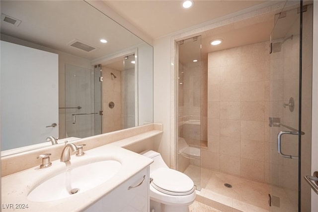 bathroom featuring vanity, toilet, and an enclosed shower