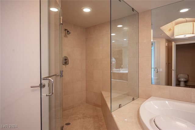 bathroom with toilet and a shower with shower door