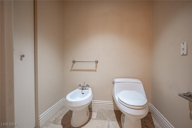 bathroom with toilet and a bidet