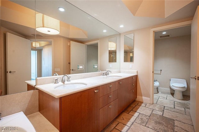 bathroom with vanity, a bidet, and toilet