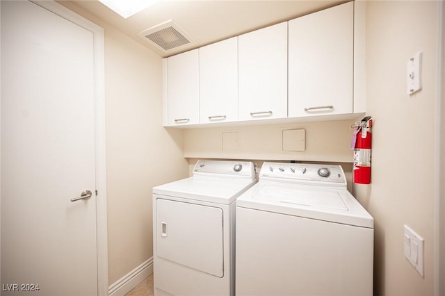 laundry room featuring cabinets and separate washer and dryer