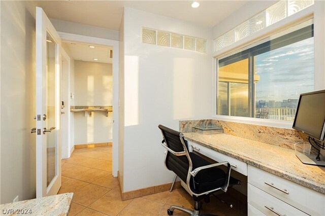 office featuring built in desk and light tile patterned floors