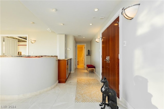 corridor with visible vents, baseboards, and recessed lighting