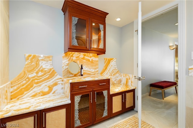 interior space with vanity and decorative backsplash