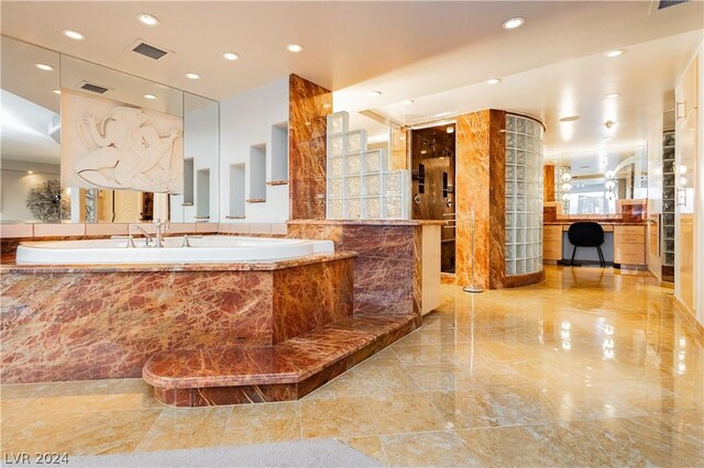 bathroom with vanity and tiled bath